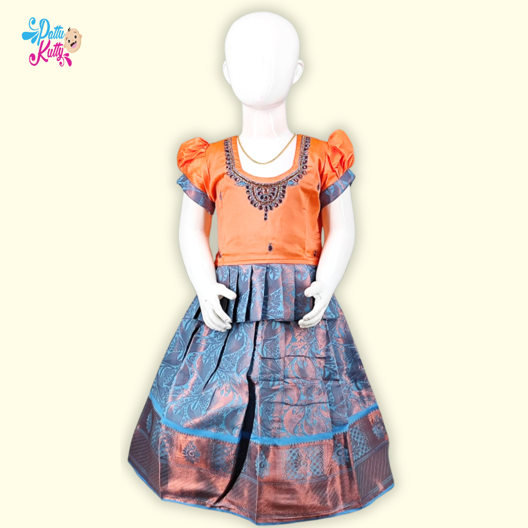 This Pattu Pavadai with Stone work neckline and Frill Design and printed skirt with copper border.
