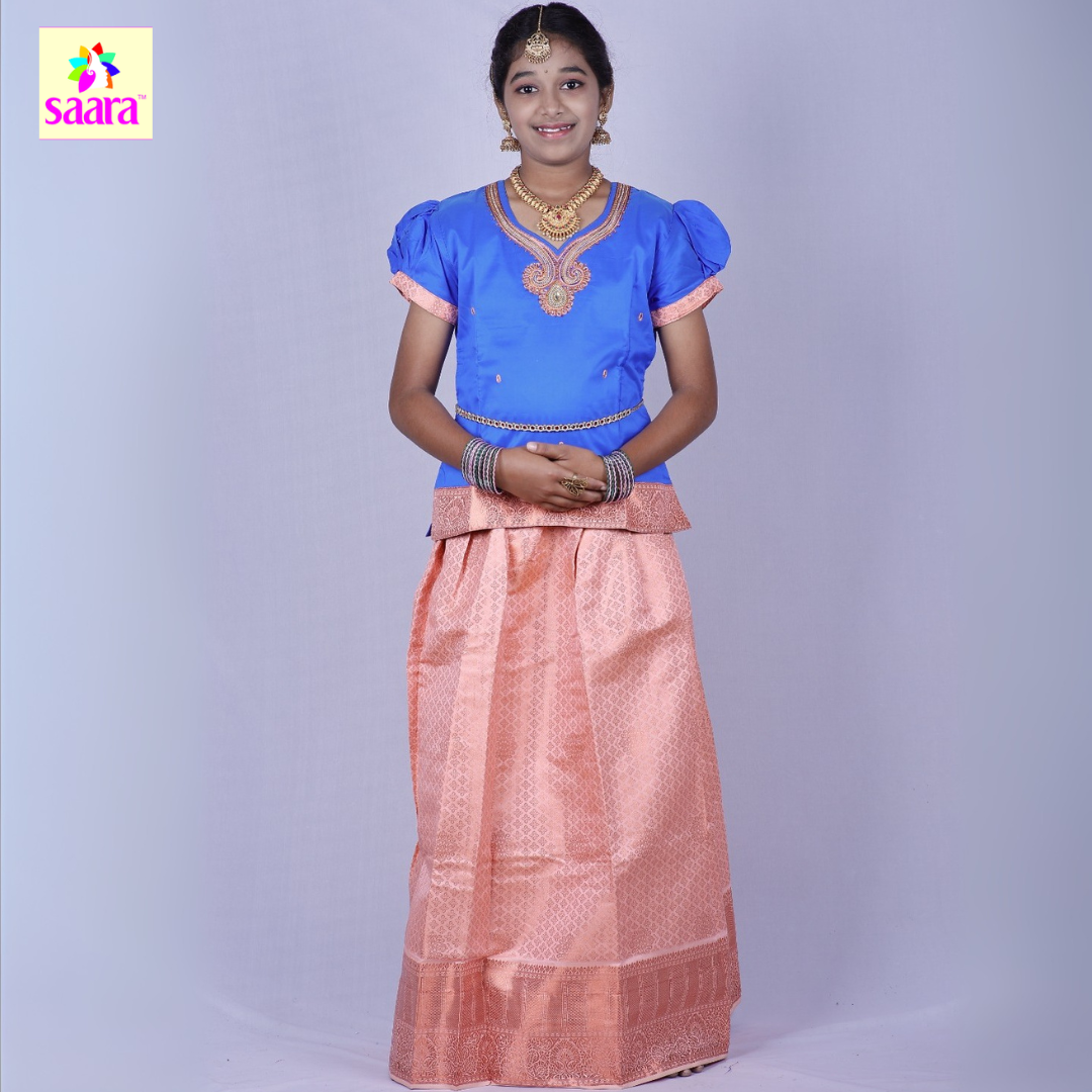 This Pattu Pavadai features Royal Blue puff-sleeve blouse with Peach embroidery and peach patchwork at hem of the sleeve and paired with Peach handloom pattu Skirt.