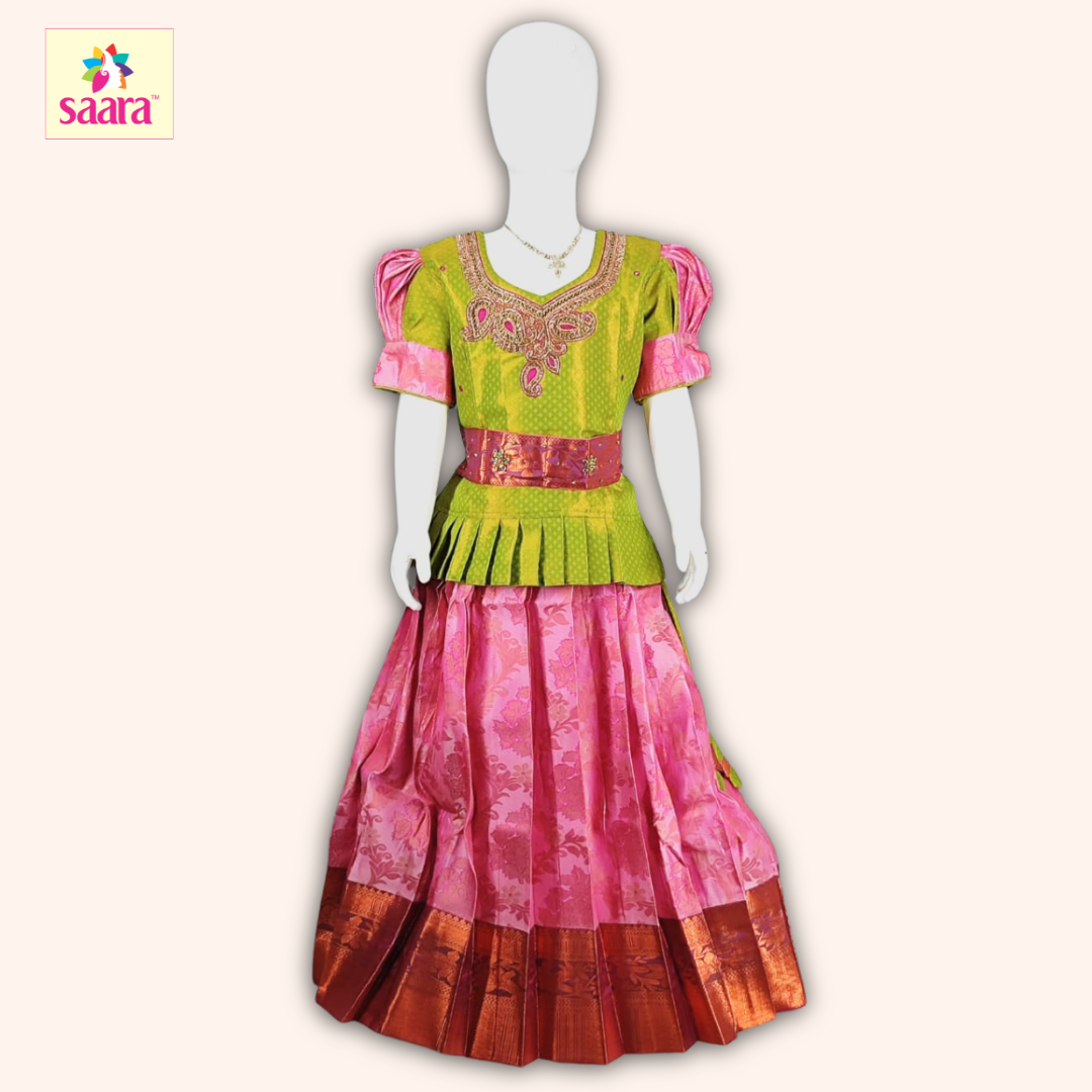 This pattu pavadai features a lime green blouse with Aari work , Green and pink puffed sleeves, and a matching pink skirt made of floral jacquard fabric