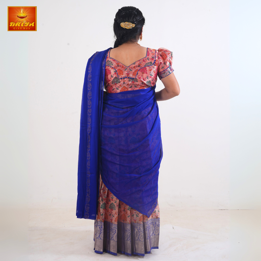 This Half saree with blue shawl with embellishment and peach floral printed Skirt ,Zari border, and matching Puff sleeve blouse with piping design with potli buttons.