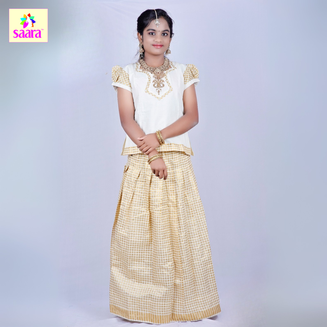 This Pattu Pavadai features white puff-sleeve blouse with gold embroidery and applique works at the top and paired with Golden checkered handloom pattu skirt