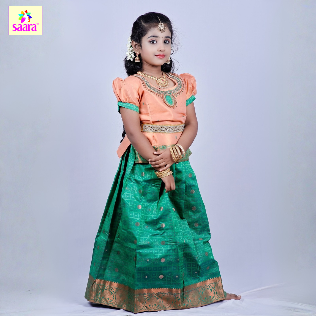 This Pattu Pavadai features Copper colour Aari worked top paired with Green skirt and Copper border.