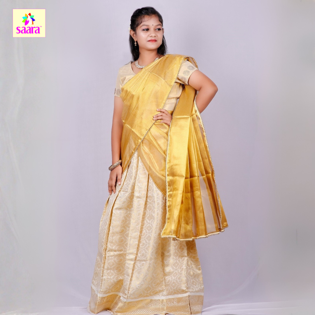 This Half Saree features golden colour shawl paired with light golden blouse and skirt.