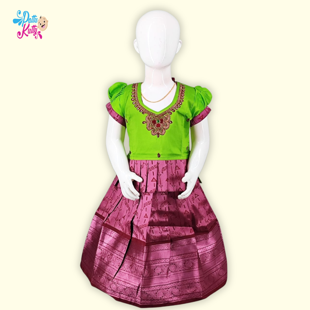 This Pattu Pavadai comes in combination with Green Stone work top with Frill Design and Pink printed skirt.