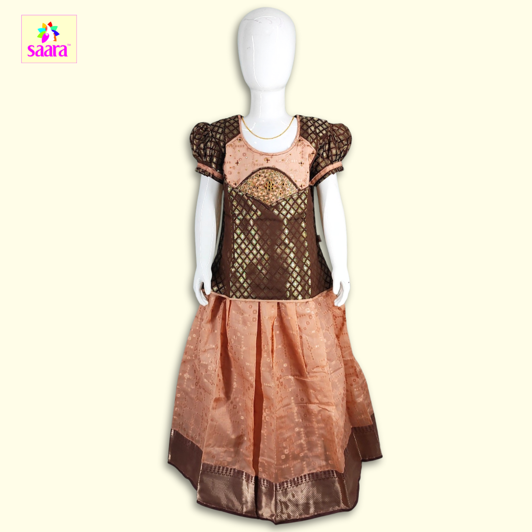 This Pattupavadai features a patch work in brown top paired with peach skirt.