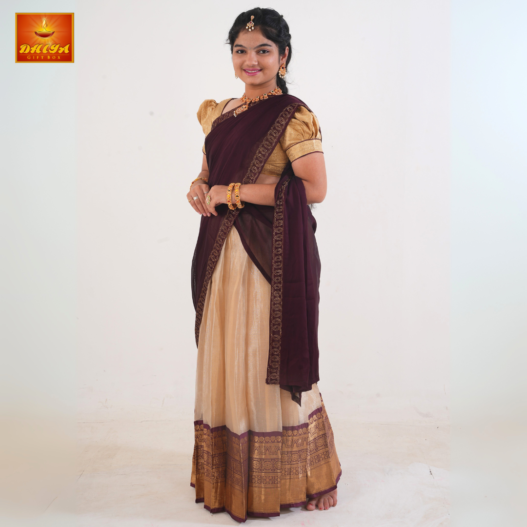 This Half saree features Brown shawl with embellishment at the hem and Beige plain Skirt ,Zari border, and matching Puff sleeve blouse.