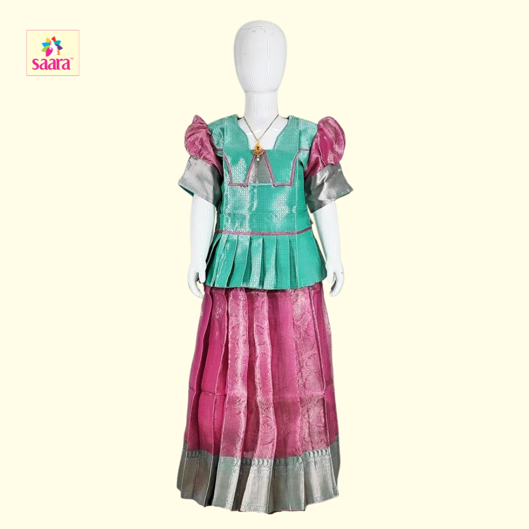 This is a Green and Pink pattupavadai with pattern work.