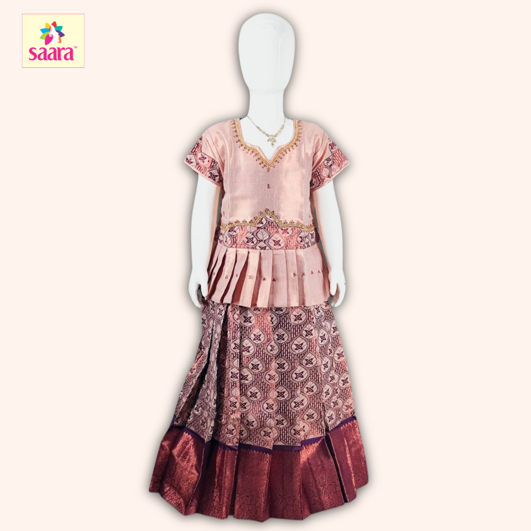 This pattu pavadai features a Copper blouse with Stone work& Patch work at hip and sleeves with a matching Brown skirt made of jacquard fabric.