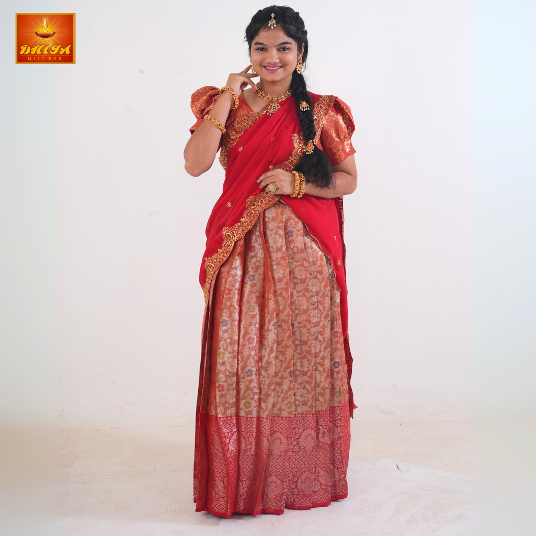 This Half saree Features Red shawl with embellishment at the hem and peach floral printed Skirt ,Zari border, and matching Puff sleeve blouse.